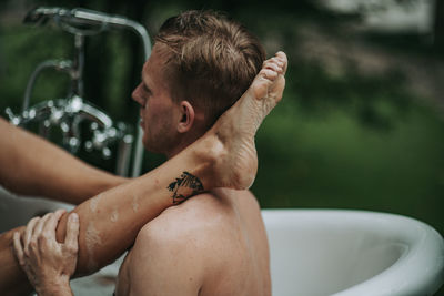 Portrait of shirtless man looking at camera