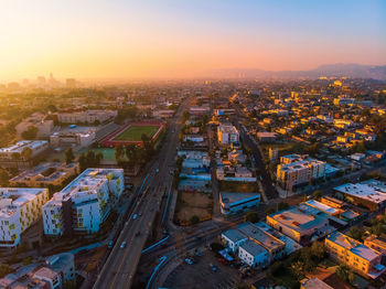 High angle view of street amidst buildings against sky during sunset