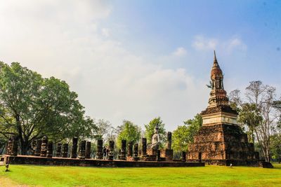 View of temple building against cloudy sky