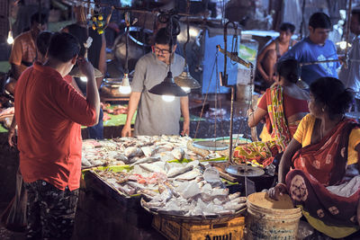 Group of people at market stall