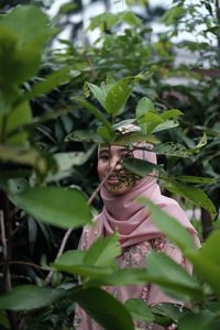 Portrait of woman with plants