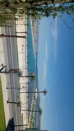 Sailboats in sea against blue sky