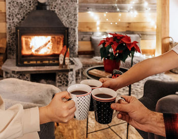 Midsection of woman holding coffee cup