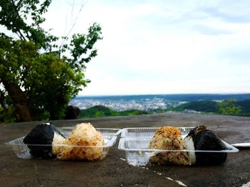 Food on table by sea against sky