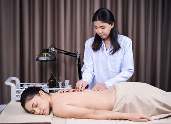 Smiling young woman lying down