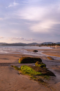 Scenic view of beach against sky during sunset