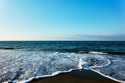 Scenic view of sea against clear blue sky