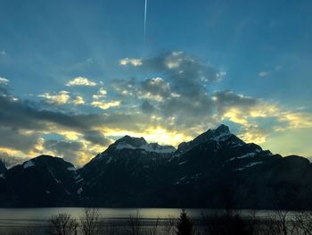 Scenic view of snowcapped mountains against sky during sunset