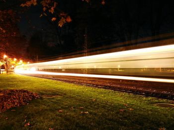 Light trails on highway by road at night