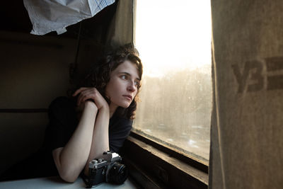 Portrait of young woman sitting at train 