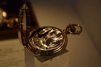 Close-up of pocket watch on table