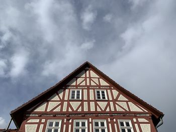 Low angle view of traditional german building against cloudy sky in eichsfeld, thuringia, germany