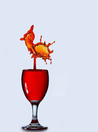 Close-up of red wine against white background