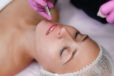 Close-up portrait of woman lying down