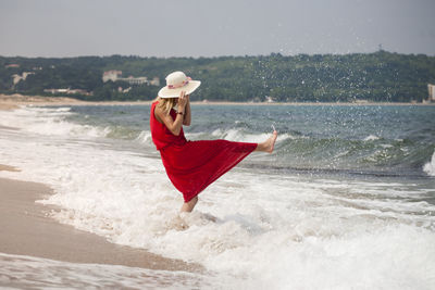 Man wearing hat while standing on beach