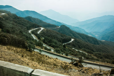 High angle view of winding road on mountain against sky