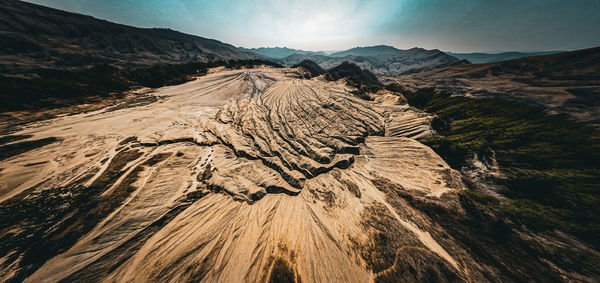 Scenic view of mud volcano against sky