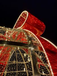 Low angle view of illuminated ferris wheel against sky at night