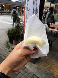 Close-up of hand holding ice cream cone