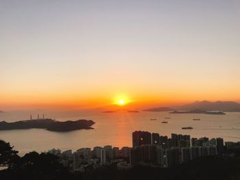 Scenic view of silhouette buildings against sky during sunset