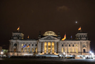 Illuminated building against sky at night