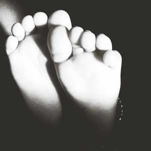 Close-up of baby feet in hand