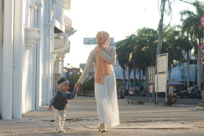 Mother and son on zebra crossing