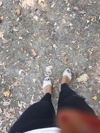 Low section of woman standing on ground