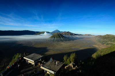 High angle view of volcanic landscape against blue sky