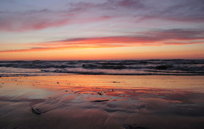 Scenic view of beach against sky during sunset