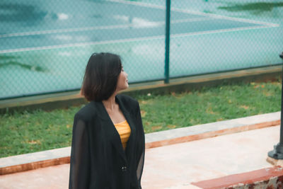 Woman looking through fence