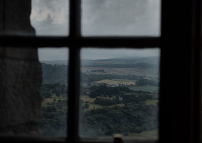 Scenic view of landscape seen through window