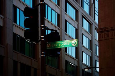 Low angle view of road sign at night