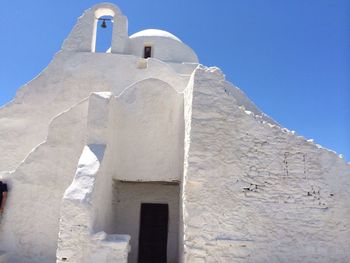 Low angle view of built structure against clear blue sky