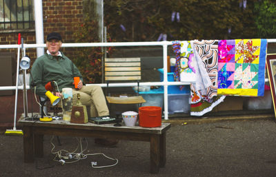 Full length of man sitting at toy on table