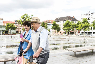 Germany, mannheim, happy senior couple with wheeled walker