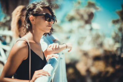 Side view of young woman wearing sunglasses