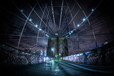 Illuminated bridge in city at night