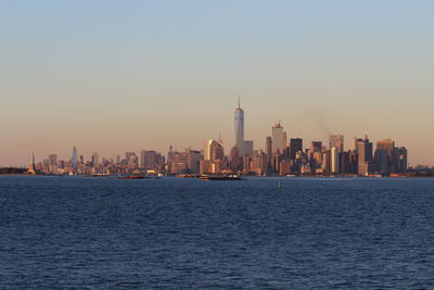 City at waterfront during sunset