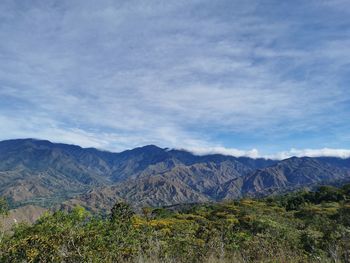 Scenic view of landscape and mountains against sky