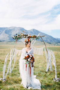 Portrait of smiling woman standing on field