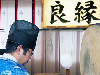 Man by drum in temple