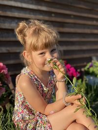 Midsection of woman holding flowering plant