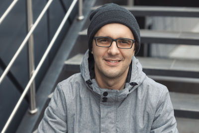 Portrait of smiling man sitting on steps