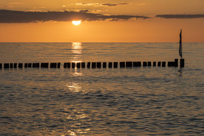 Scenic view of sea against orange sky