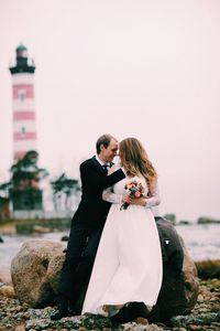 Man and woman with arms outstretched