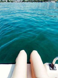 Low section of woman relaxing in swimming pool