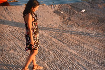 Young woman standing at beach