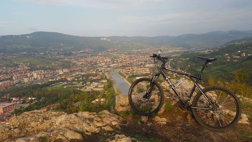 Bicycle on mountain against sky