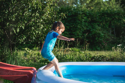 Girl playing in inflatable tub